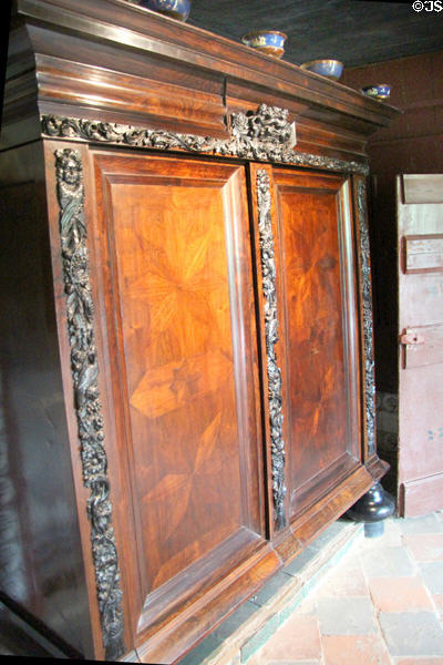 Large cabinet placed next to doorway typical of farmhouse from Staphorst is at Arnhem Openlucht Museum. Arnhem, Netherlands.