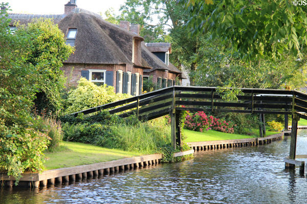 Wooden pedestrian bridge over canal. Giethoorn, Netherlands.