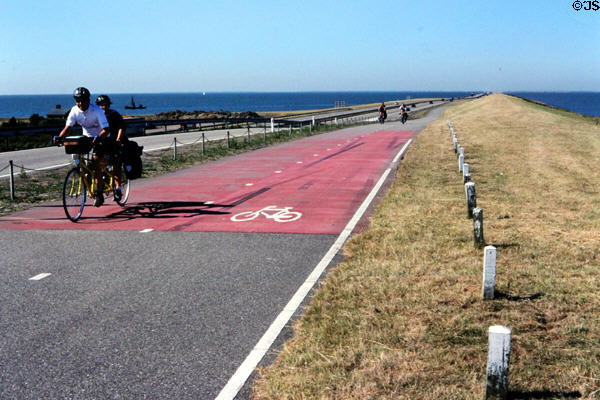 Bicyclists riding along the 30 km dike in Afsliuitdijk. Netherlands.