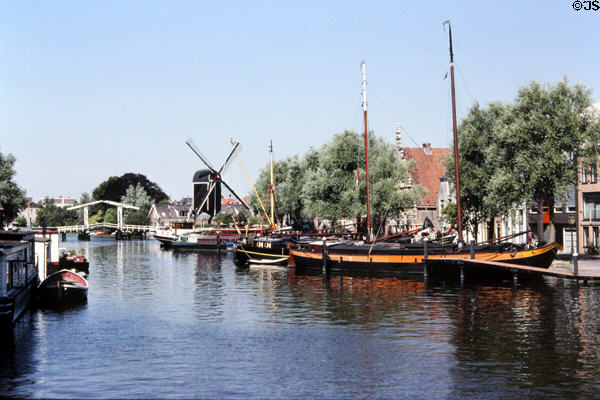 View of windmill & barges on Rijn Galgewater. Leyden, Netherlands.