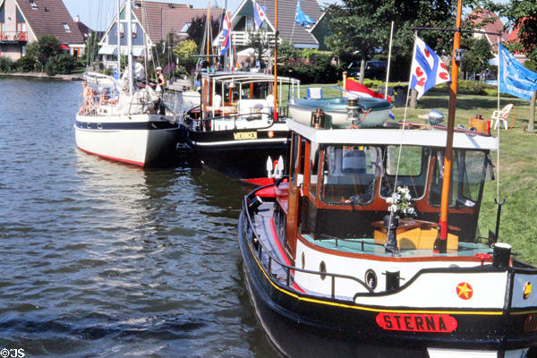 Boats moored along the canal. Sloten, Netherlands.