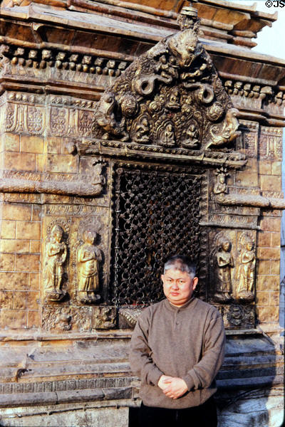 Monk poses in front of Swayambhunath Buddhist Temple in Katmandu. Nepal.