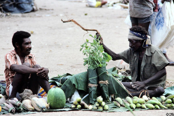 Vendors socializing amongst their produce at the Port Moresby market. Papua New Guinea.