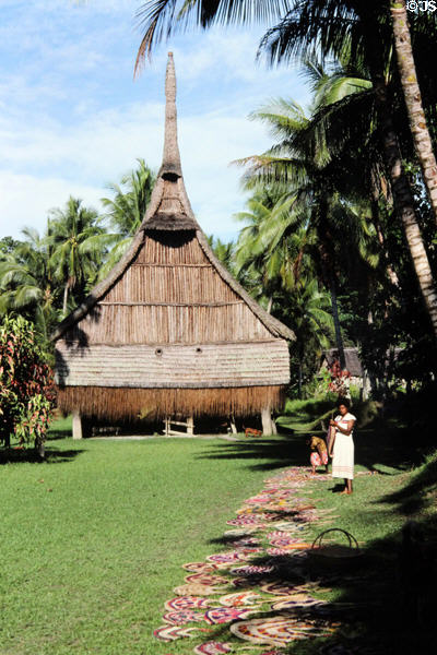 Grass leads up to a house Tambaran in Palembei. Papua New Guinea.