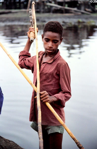 Young boy using a device to throw a spear in Kamburamba. Papua New Guinea.
