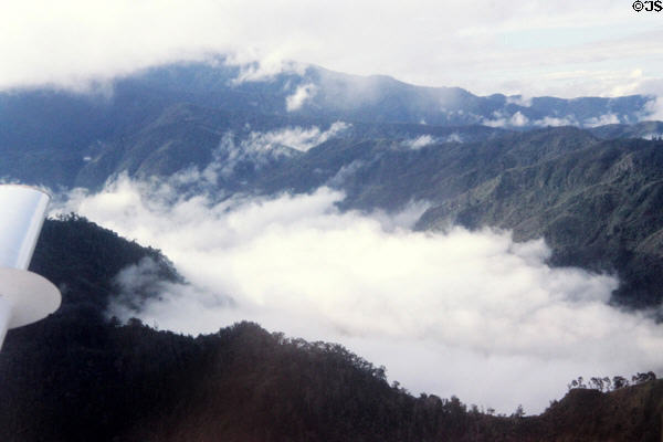 Clouds seen floating across the mountains during a flight to the highlands. Papua New Guinea.