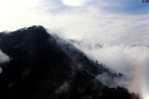 Flying through cloudy covered mountains. Papua New Guinea.