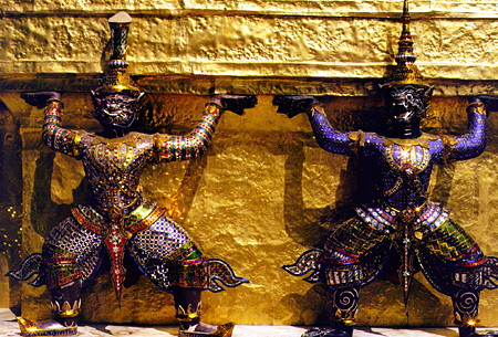 Statues surrounding one of the many towers of the Grand Palace in Bangkok. Thailand.