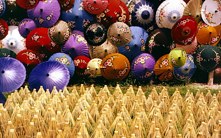 Variety of hand-painted paper umbrellas drying at the umbrella factory in Chiang Mai. Thailand.