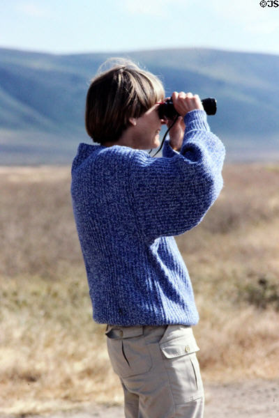 Tourist scans Ngorongoro Park. Tanzania.