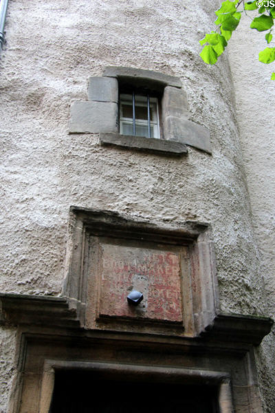 Ancient wall with faded boot maker sign on Lady Stair's Close opposite Writers' Museum. Edinburgh, Scotland.