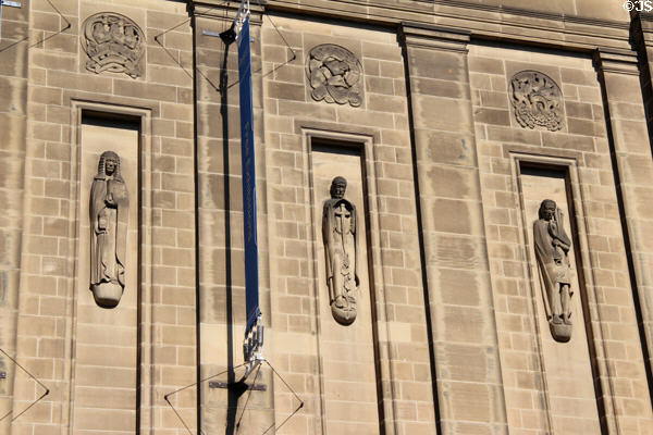 Sculpted figures by Hew Lorimer under rondels by E. Dempster on facade of National Library of Scotland. Edinburgh, Scotland.