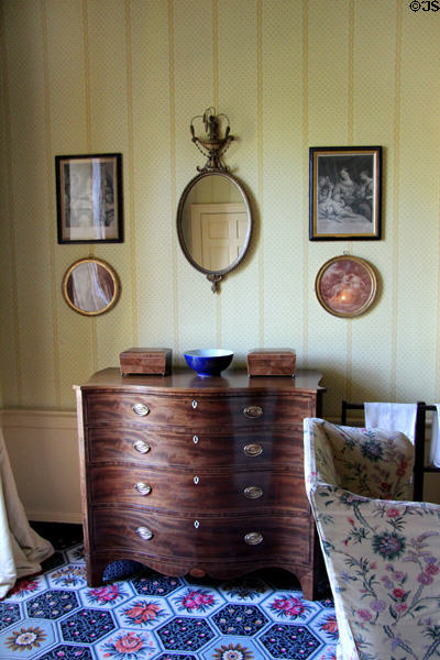 Scottish serpentine-fronted chest of drawers (late 18thC) under array of etchings & mirror in bedchamber at Georgian House museum. Edinburgh, Scotland.