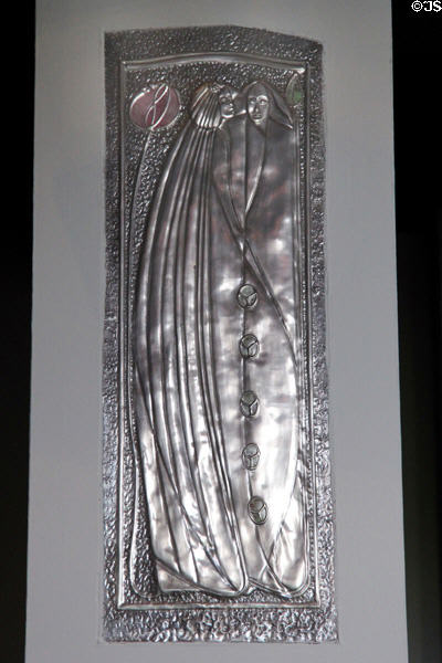 Metal plaque in style of Margaret Macdonald on hall pillar at House for an Art Lover. Glasgow, Scotland.