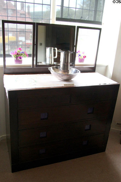 Chest of drawers with mirror supports silvered pitcher & basin at Hill House. Helensburgh, Scotland.