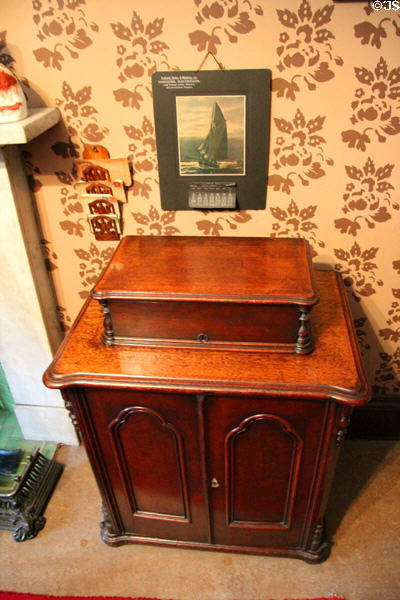 Cabinet in parlor against wallpaper at Tenement House museum. Glasgow, Scotland.