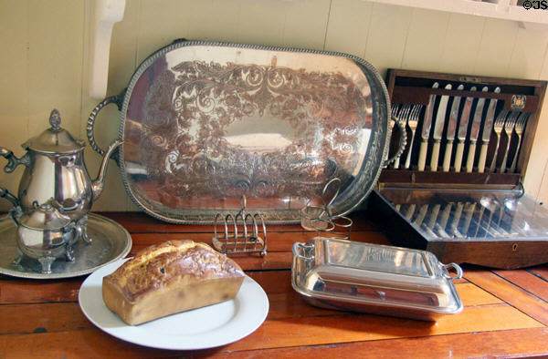 Serving dishes in poop cabin of Glenlee Tall Ship. Glasgow, Scotland.