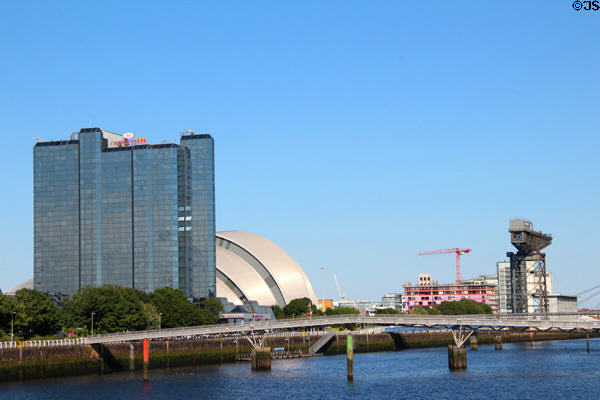 Clyde River with footbridge to Pacific Quay, Crowne Plaza tower, Armadillo & dockyard crane. Glasgow, Scotland.
