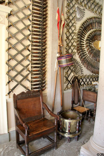 Display of blades over great armchair (1692) in Armory at Culzean Castle. Maybole, Scotland.