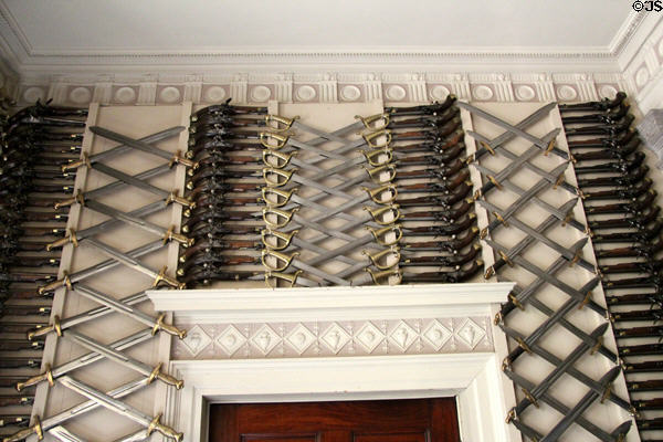Collection of arms around Robert Adam fireplace in Armory at Culzean Castle. Maybole, Scotland.