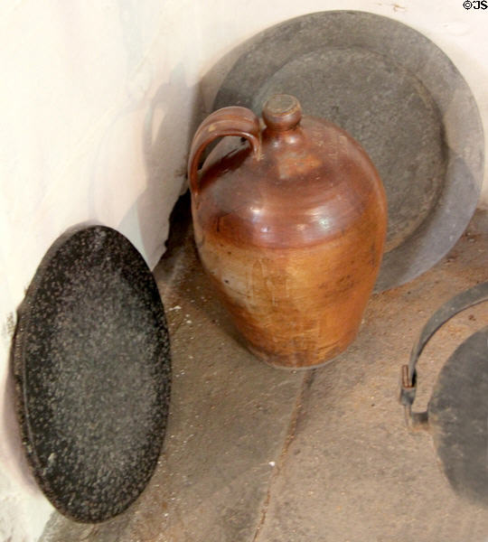 Iron girdle by hammermen in front of ceramic crock at The Study. Culross, Scotland.