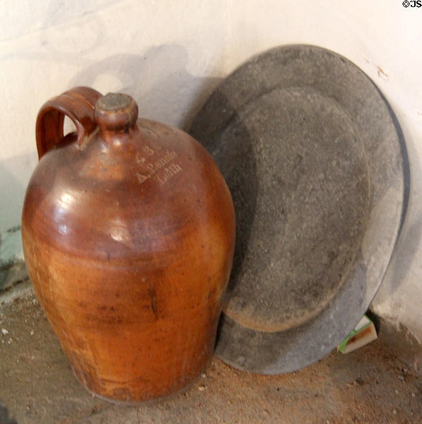 Ceramic crock marked A. Rennie, Leith in front of metal plate at The Study. Culross, Scotland.