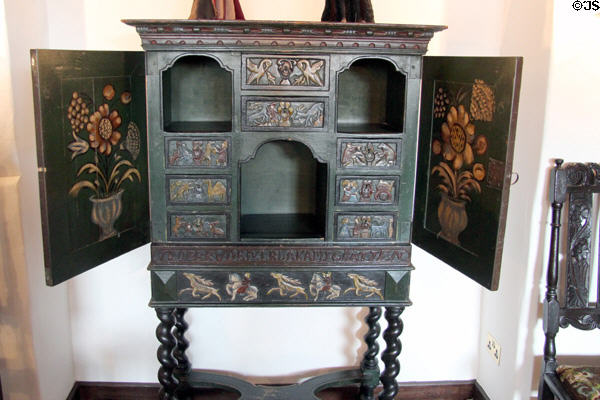 Interior details of Scandinavian bridal cabinet on legs carved with trolls at The Study. Culross, Scotland.