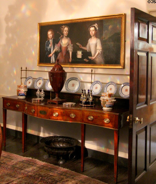Side board with China & serving dishes under family portrait typical of the era at Georgian House Museum. Bristol, England.