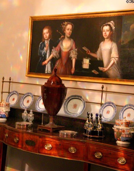 Detail of side board with China & serving dishes under family portrait typical of the era at Georgian House Museum. Bristol, England.
