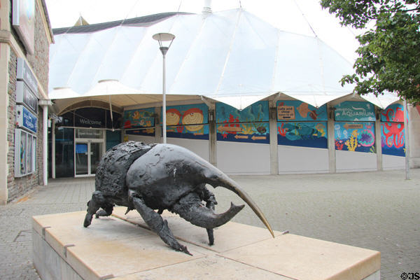 Bristol Aquarium & giant botanical house with bronze sculpture of Rhinoceros beetle (1999) by Nicola Hicks. Bristol, England.