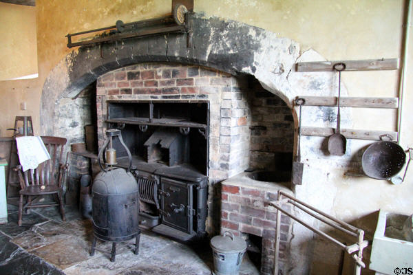 Kitchen fireplace with cooking equipment at Chastleton House. Moreton-in-Marsh, England.