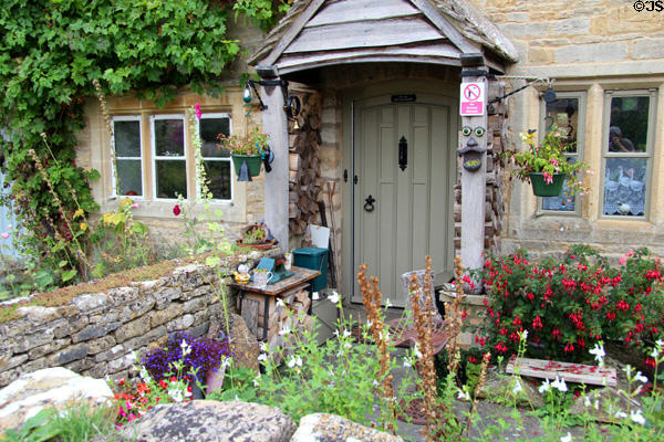 Home with profusion of plantings in front garden. Lower Slaughter, England.