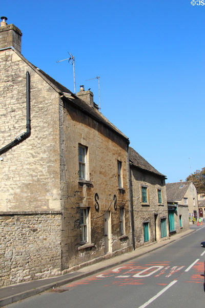 Vintage building on High Street with S-shaped supports to keep stone facade from bowing outward. Northleach, England.