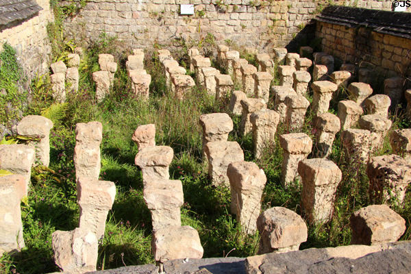 Limestone pillars of hypocaust, underfloor heating system, at Chedworth Roman Villa. England.