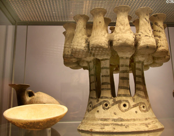 Cycladic terracotta painted kernos offering ring (c2200-1800 BCE) from Phylakopi 1 culture over other Cycladic vessels at British Museum. London, United Kingdom.