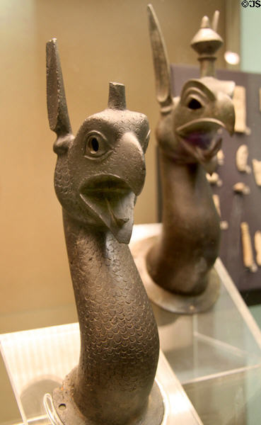 East Greek bronze griffin heads once attached to cauldron (7thC BCE) from Rhodes (larger) & Samos (smaller) at British Museum. London, United Kingdom.