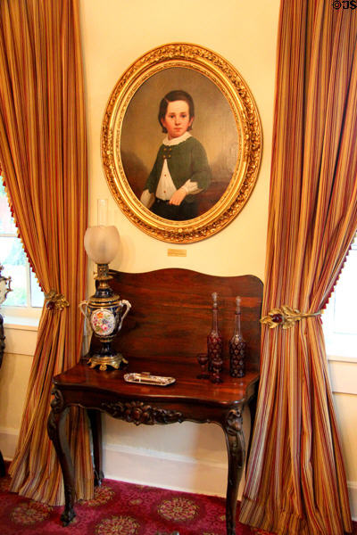 Portrait of young boy over card table at Conde-Charlotte Museum. Mobile, AL.