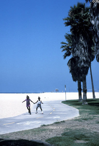 Youngsters roller skate along Venice Beach. Venice, CA.
