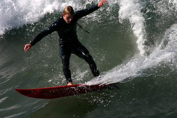 Surfing beside pier in Ocean Beach. San Diego, CA.