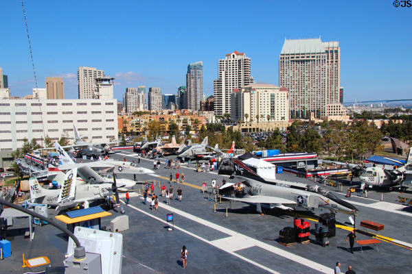 San Diego skyline over Midway aircraft carrier & aircraft. San Diego, CA.