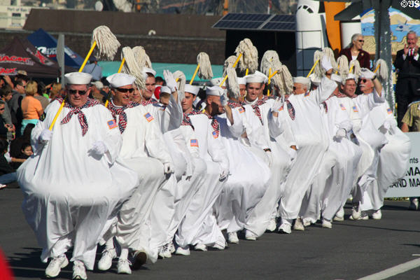 Marching comic sailor swabies with mops at Balloon Parade. San Diego, CA.