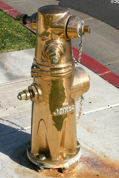 Polished brass fireplug as memorial to firefighters who died on 9/11 in front of Fire Station. Oceanside, CA.