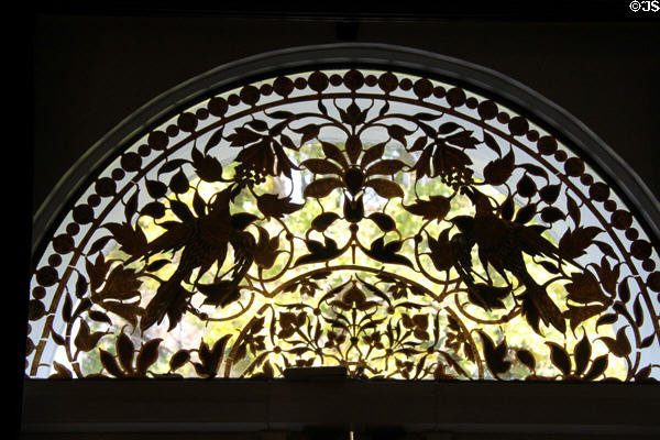Metal screen with birds eating berries at Clarke Estate. Santa Fe Springs, CA.