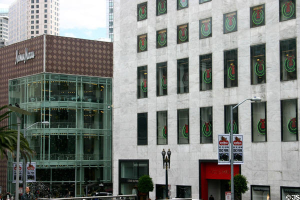White marbled I. Magnin (now Macy's building) (1905-10) with Nieman Marcus beyond on Union Square. San Francisco, CA. Architect: Reid Brothers.