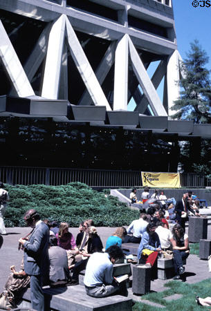 People enjoy sunshine at base of Transamerica Pyramid. San Francisco, CA.