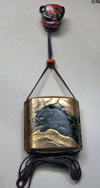 Inro with bear design (1700-1900) & Netsuke with lion dancer head (1800-1900) from Japan at Asian Art Museum. San Francisco, CA.