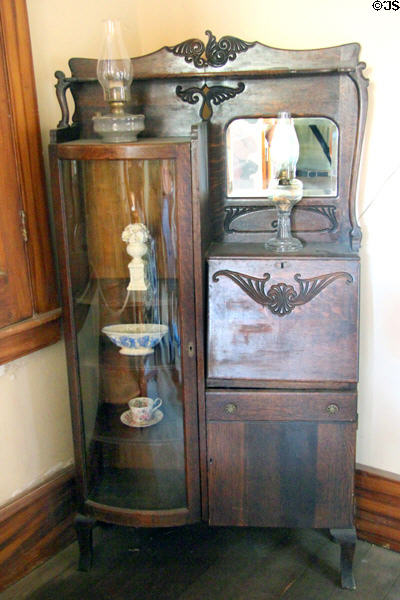 Antique combined curved glass fronted display case & drop front desk in in residence part of Wells Fargo office at Columbia State Historic Park. Columbia, CA.