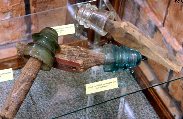 Telegraph glass insulators on wooden pins at El Dorado County Historical Museum. Placerville, CA.