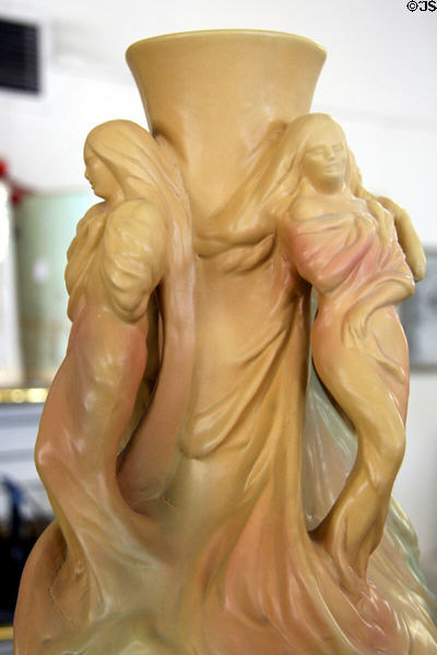 Art Nouveau woman beside vase by Van Briggle Pottery. Colorado Springs, CO.