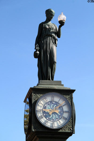 Statue of woman holding lamp atop Wheeler Town Clock. Manitou Springs, CO.